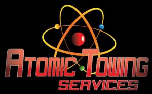 Company logo for Atomic Towing Services with an orange-yellow atomic symbol above a red gradient wordmark on a black background.